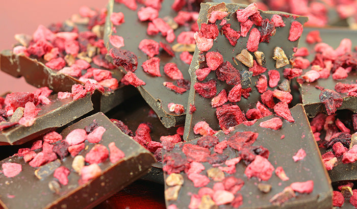Chocolate covered in red and pink sprinkles.