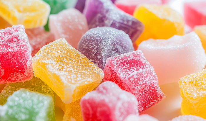Colorful gummy candies in a close-up shot, featuring various shapes and flavors